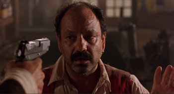 Movie still from “Desperado” (1995), directed by Robert Rodriguez – A person holding a gun; Close Up shot, Low angle