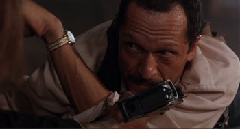 Movie still from “Desperado” (1995), directed by Robert Rodriguez – A person holding a cell phone; Close Up shot, High angle