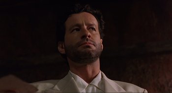 Movie still from “Desperado” (1995), directed by Robert Rodriguez – A person with a beard looking upward; Close Up shot, Low angle