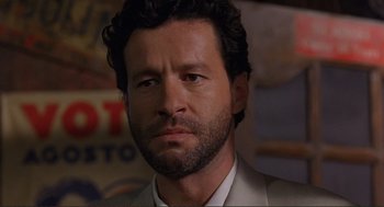 Movie still from “Desperado” (1995), directed by Robert Rodriguez – A person wearing a suit and tie; Close Up shot, Low angle