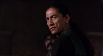 Movie still from “Desperado” (1995), directed by Robert Rodriguez – A person wearing a black shirt; Close Up shot, Low angle