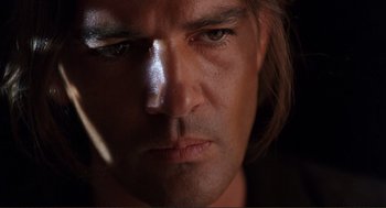Movie still from “Desperado” (1995), directed by Robert Rodriguez – A man's face in the dark; Close Up shot, Low angle