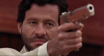 Movie still from “Desperado” (1995), directed by Robert Rodriguez – A person holding a gun; Close Up shot, Low angle