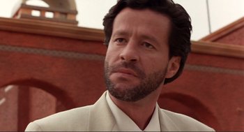 Movie still from “Desperado” (1995), directed by Robert Rodriguez – A person wearing a suit and beard; Close Up shot, Low angle