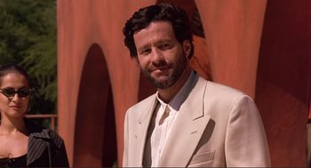 Movie still from “Desperado” (1995), directed by Robert Rodriguez – A man wearing a suit and a white shirt; Close Up shot, Low angle