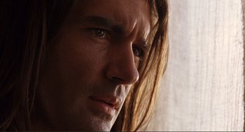Movie still from “Desperado” (1995), directed by Robert Rodriguez – A man with long hair looking into the distance; Close Up shot, Low angle