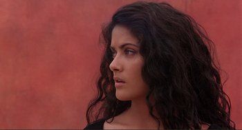 Movie still from “Desperado” (1995), directed by Robert Rodriguez – A person with long curly black hair; Close Up shot, Low angle