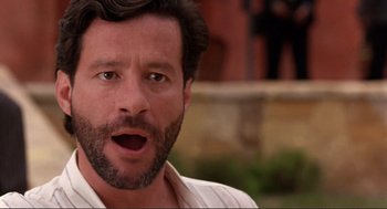 Movie still from “Desperado” (1995), directed by Robert Rodriguez – A person wearing a white shirt; Close Up shot, Low angle