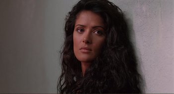 Movie still from “Desperado” (1995), directed by Robert Rodriguez – A person with long black curly hair; Close Up shot, High angle