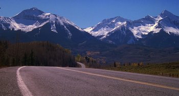 Movie still from “Desperate Hours” (1990), directed by Michael Cimino – A road with a mountain in the background; Extreme Wide shot, High angle