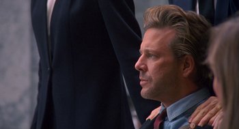 Movie still from “Desperate Hours” (1990), directed by Michael Cimino – A person wearing a suit and tie; Close Up shot, Over the shoulder angle