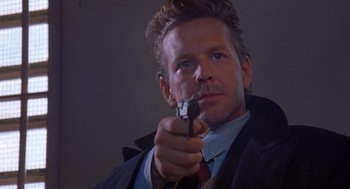 Movie still from “Desperate Hours” (1990), directed by Michael Cimino – A person holding a gun; Close Up shot, Low angle