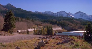 Movie still from “Desperate Hours” (1990), directed by Michael Cimino – A view of a lake and mountains in the distance; Extreme Wide shot, High angle