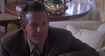 Movie still from “Desperate Hours” (1990), directed by Michael Cimino – A person wearing a suit and tie; Close Up shot, Over the shoulder angle