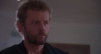 Movie still from “Desperate Hours” (1990), directed by Michael Cimino – A person wearing a black shirt; Close Up shot, Low angle