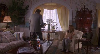 A man and a woman sitting at a table in a living room
