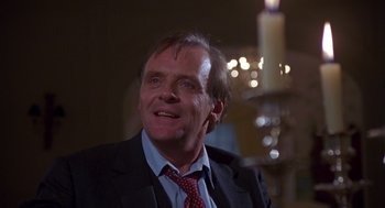 Movie still from “Desperate Hours” (1990), directed by Michael Cimino – A person wearing a suit and a tie; Close Up shot, Low angle