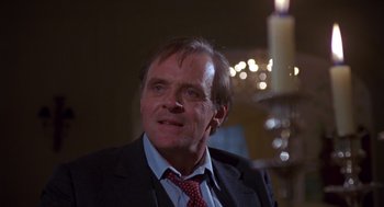 Movie still from “Desperate Hours” (1990), directed by Michael Cimino – A person wearing a suit and tie; Close Up shot, Low angle