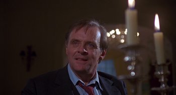 Movie still from “Desperate Hours” (1990), directed by Michael Cimino – A person wearing a suit and tie; Close Up shot, Low angle