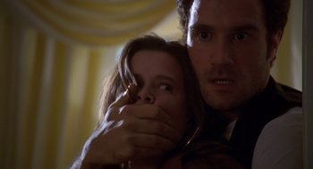 Movie still from “Desperate Hours” (1990), directed by Michael Cimino – A man and a woman are holding their hands over their faces; Close Up shot, Low angle