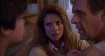 Movie still from “Desperate Hours” (1990), directed by Michael Cimino – A woman sitting next to a man on a couch; Close Up shot, Over the shoulder angle