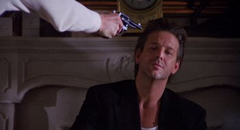 Movie still from “Desperate Hours” (1990), directed by Michael Cimino – A man getting his hair cut by a man with a gun; Close Up shot, Low angle