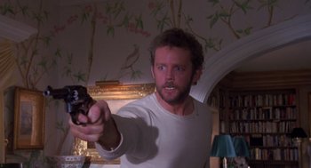 Movie still from “Desperate Hours” (1990), directed by Michael Cimino – A man holding a remote control in his hand; Close Up shot, Low angle