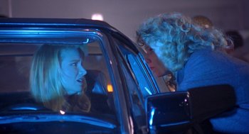 Movie still from “Desperate Hours” (1990), directed by Michael Cimino – Two women in the back seat of a black car; Close Up shot, Over the shoulder angle