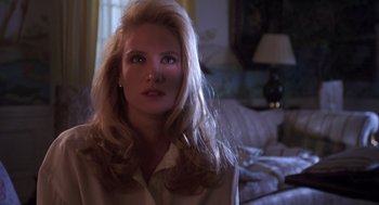 Movie still from “Desperate Hours” (1990), directed by Michael Cimino – A woman with long blonde hair is looking at the camera; Close Up shot, Over the shoulder angle