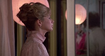Movie still from “Desperately Seeking Susan” (1985), directed by Susan Seidelman – A young woman with blonde ringlets in front of a mirror; Close Up shot, Over the shoulder angle