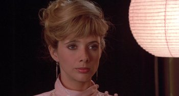 Movie still from “Desperately Seeking Susan” (1985), directed by Susan Seidelman – A person wearing a pink shirt; Close Up shot, Over the shoulder angle