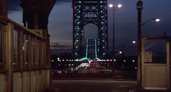 Movie still from “Desperately Seeking Susan” (1985), directed by Susan Seidelman – A view of a bridge at night from the street; Extreme Wide shot, High angle