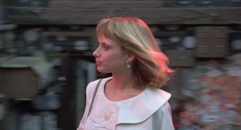Movie still from “Desperately Seeking Susan” (1985), directed by Susan Seidelman – A woman with blonde hair is walking down the street; Close Up shot, Low angle