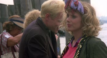 Movie still from “Desperately Seeking Susan” (1985), directed by Susan Seidelman – A man and a woman talking to each other; Close Up shot, Over the shoulder angle