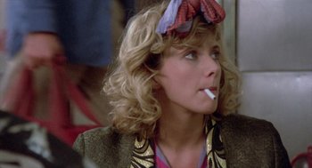 Movie still from “Desperately Seeking Susan” (1985), directed by Susan Seidelman – A person with a cigarette in her mouth; Close Up shot, Over the shoulder angle