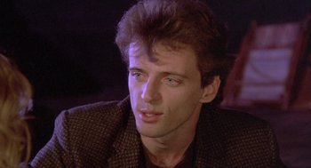 Movie still from “Desperately Seeking Susan” (1985), directed by Susan Seidelman – A person wearing a jacket; Close Up shot, Low angle