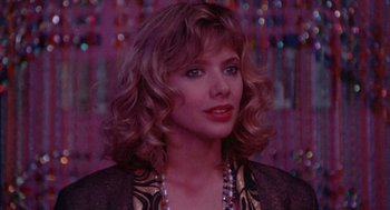 Movie still from “Desperately Seeking Susan” (1985), directed by Susan Seidelman – A person wearing a necklace; Close Up shot, Over the shoulder angle