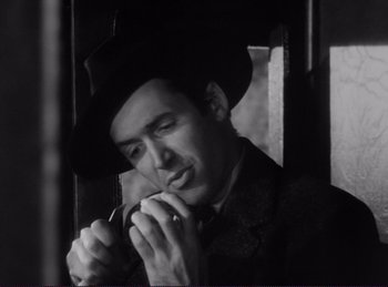 Movie still from “Destry Rides Again” (1939), directed by George Marshall – A black and white photo of a man smoking a pipe; Close Up shot, Low angle