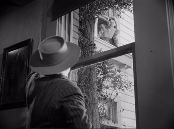 Movie still from “Destry Rides Again” (1939), directed by George Marshall – An old photo of a man looking out of a window; Wide shot, Low angle