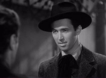 Movie still from “Destry Rides Again” (1939), directed by George Marshall – A black and white photo of a man wearing a hat; Close Up shot, Over the shoulder angle