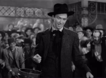 Movie still from “Destry Rides Again” (1939), directed by George Marshall – A black and white photo of a man in a crowd; Medium shot, Low angle