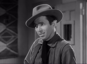 Movie still from “Destry Rides Again” (1939), directed by George Marshall – A black and white photo of a man wearing a hat; Close Up shot, Over the shoulder angle