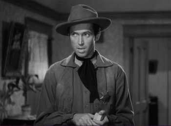 Movie still from “Destry Rides Again” (1939), directed by George Marshall – A black and white photo of a man in a hat and tie; Close Up shot, Low angle