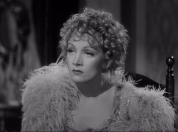 Movie still from “Destry Rides Again” (1939), directed by George Marshall – A black - and - white photo of a woman with curly hair; Close Up shot, High angle