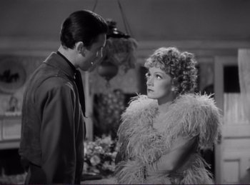 Movie still from “Destry Rides Again” (1939), directed by George Marshall – A man and a woman standing next to each other; Medium shot, Over the shoulder angle