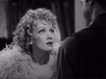 Movie still from “Destry Rides Again” (1939), directed by George Marshall – An old photo of a woman looking at a man; Close Up shot, High angle