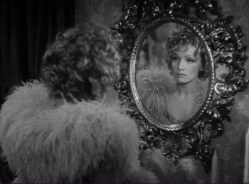 Movie still from “Destry Rides Again” (1939), directed by George Marshall – A black and white photo of a woman in a mirror; Close Up shot, Over the shoulder angle