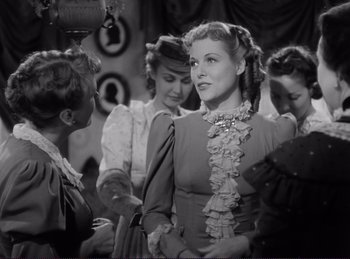 Movie still from “Destry Rides Again” (1939), directed by George Marshall – A group of women standing next to each other in a room; Medium shot, Over the shoulder angle