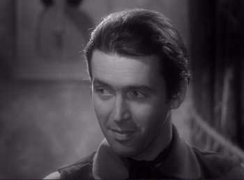 Movie still from “Destry Rides Again” (1939), directed by George Marshall – A black - and - white photo of a man in a suit; Close Up shot, High angle