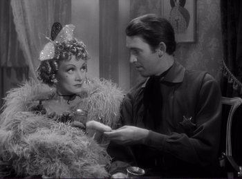 Movie still from “Destry Rides Again” (1939), directed by George Marshall – A man and a woman are standing next to each other; Medium shot, Over the shoulder angle